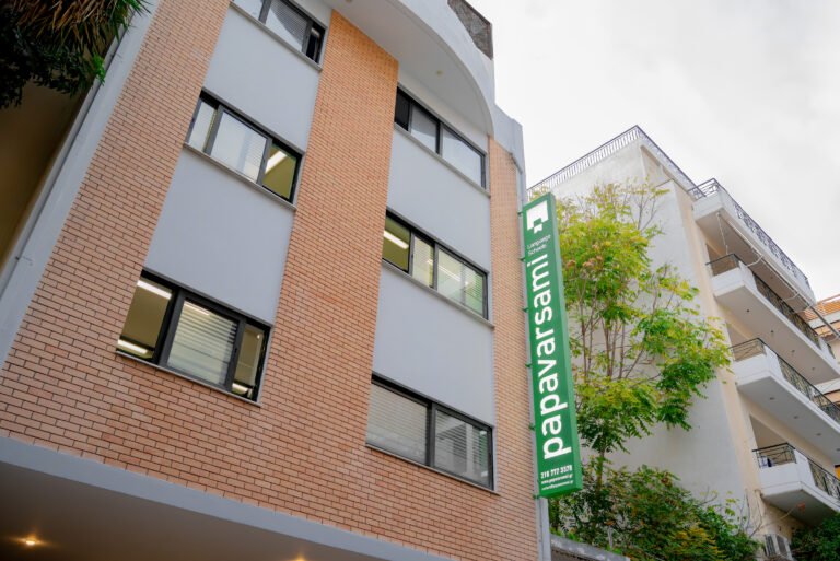 Exterior low-angle view of the modern language school building with a vertical sign.